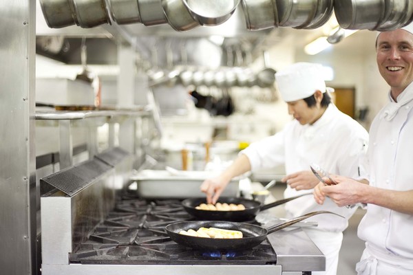 Aidan Dickson and Taro Isayama cooking the salmon and prawn boudin